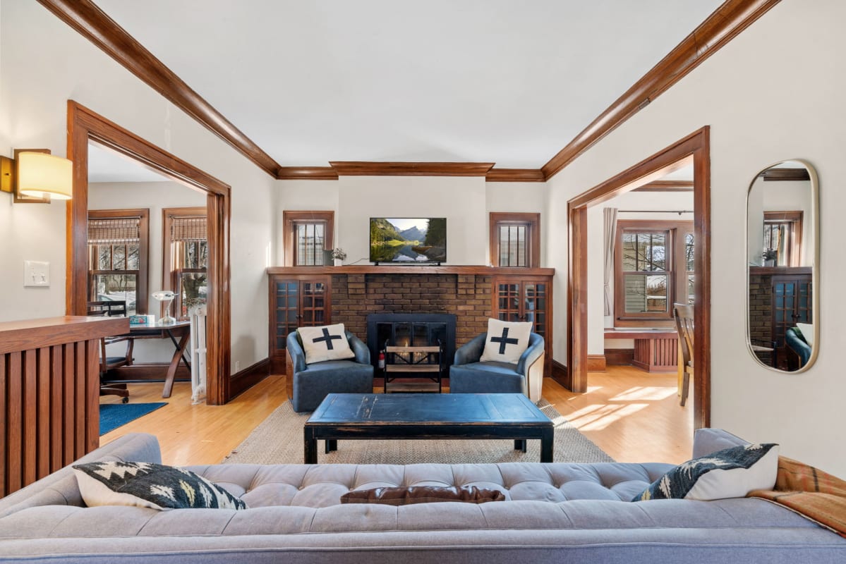 Relax in your elegant living room with rich wood trim, cozy fireplace, and plush seating perfect for gathering with loved ones.