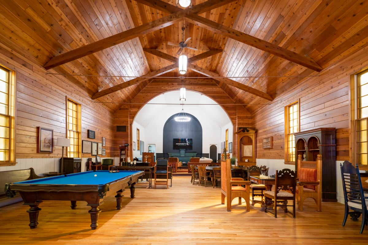 Unwind in your rustic game room with vaulted wood ceilings, where you'll find a billiard table and cozy seating for memorable evenings.