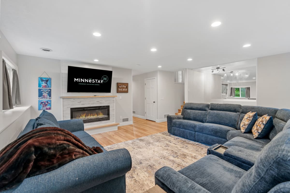 Unwind in your spacious living room with plush sectional seating, warm fireplace, and large TV for cozy movie nights together.