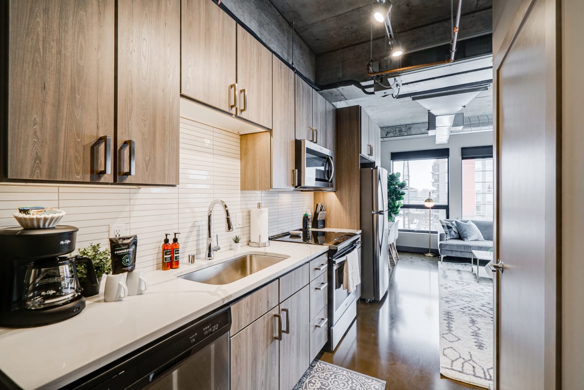 Your sleek modern kitchen awaits with warm wood cabinetry, stainless steel appliances, and everything needed to create memorable meals during your stay.
