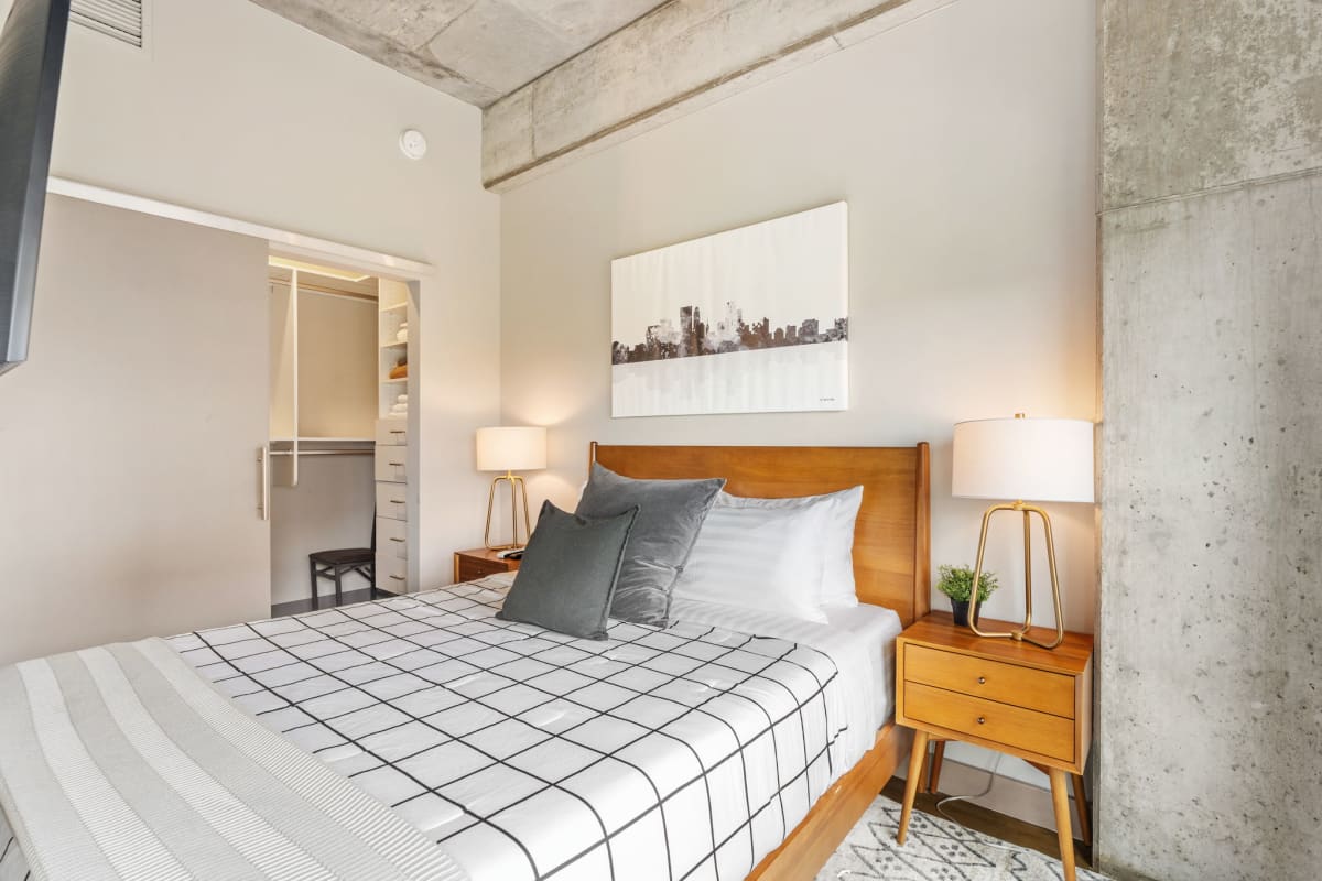 Settle into your stylish bedroom featuring warm wood accents, crisp linens, and modern industrial touches that create the perfect urban retreat.