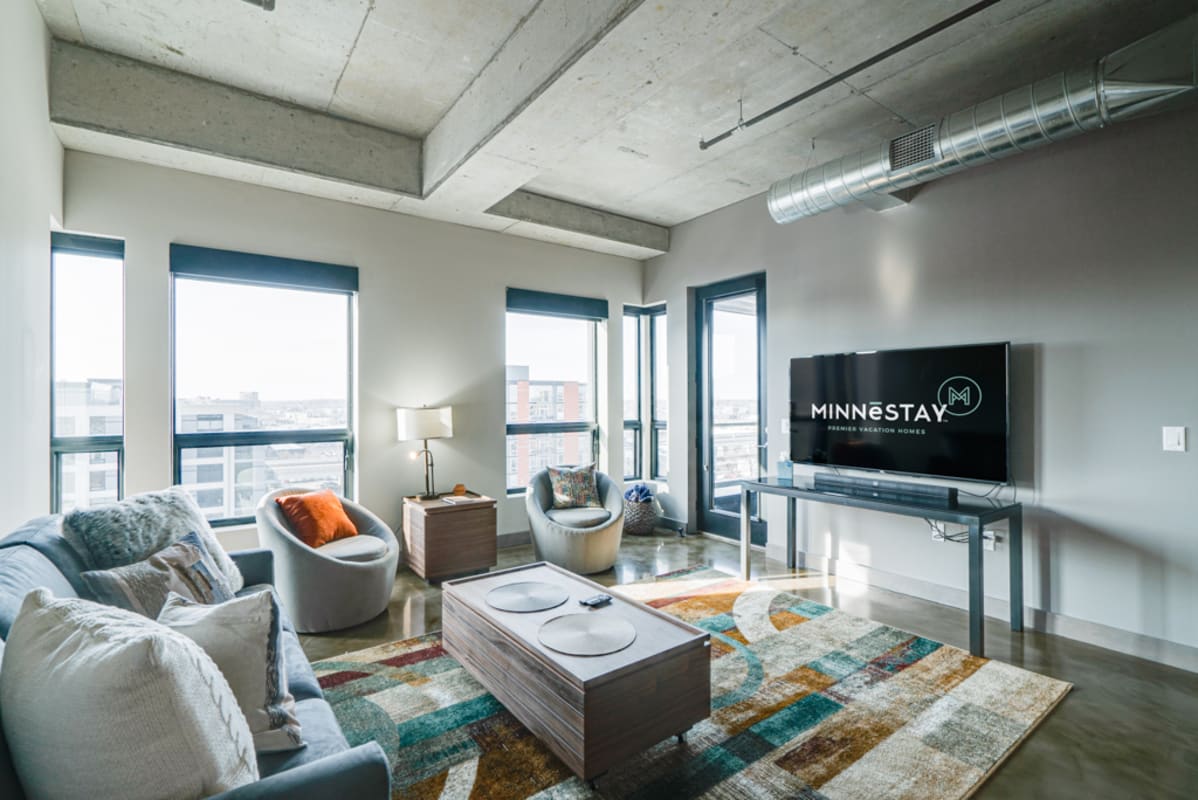 Relax in your stylish loft with exposed concrete ceilings, floor-to-ceiling windows, and modern furnishings that create the perfect urban retreat.