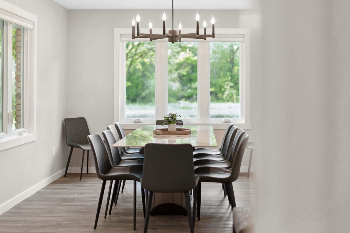 Gather around your elegant dining table for memorable meals, with natural light streaming through windows overlooking peaceful garden views.