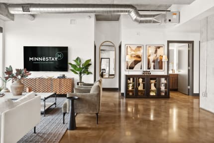 Modern living room with contemporary furniture and decor elements, featuring a TV display.