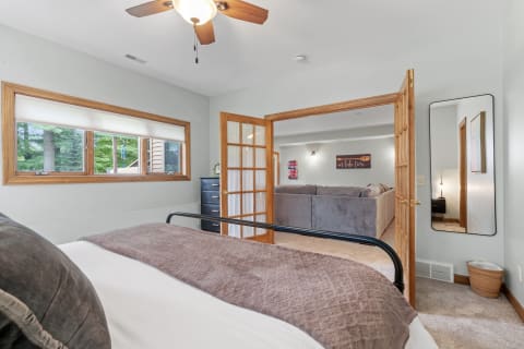 Cozy bedroom with a view of the living area beyond.