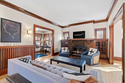 Cozy living room with a blue sofa, wooden coffee table, and a fireplace.