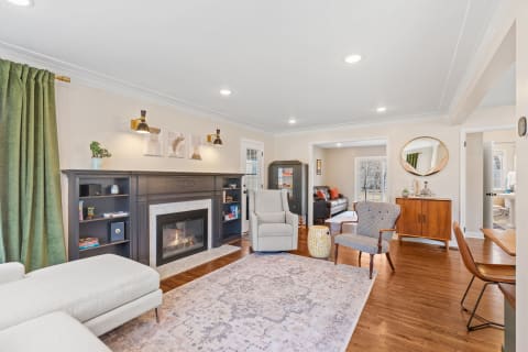 A stylish living room with sectional sofa, fireplace, and decorative artwork.