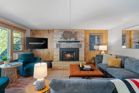 Warm living room with a fireplace and comfortable seating.