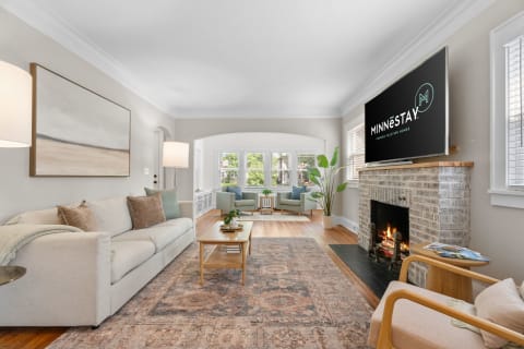 Cozy living room with a sofa, coffee table, and fireplace, adorned with modern decor.