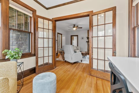 Interior view of a cozy living room with French doors and modern decor.