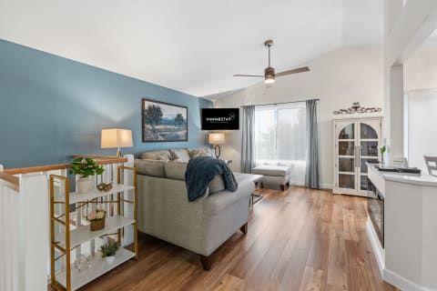 Cozy living room with gray sectional sofa, decorative pillows, and modern decor.