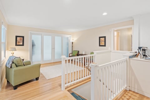 Interior view of a living area with olive-green furniture and soft lighting.