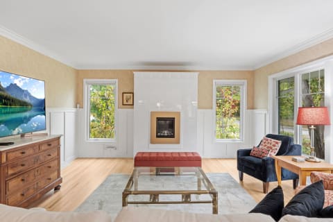 Stylish living room with fireplace, TV, and comfortable seating.