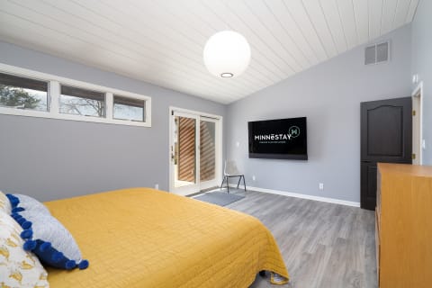 Cozy modern bedroom with yellow bedding and stylish decor.