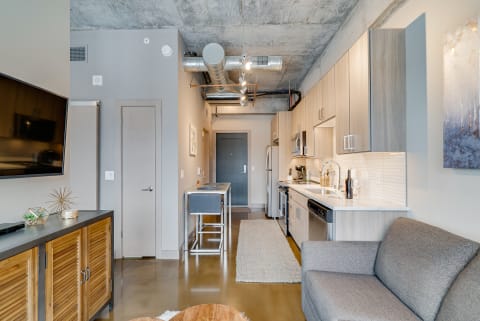 Interior view of a contemporary apartment with a kitchen and living room.