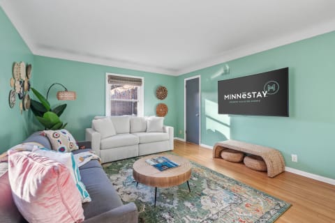 Cozy living room with turquoise walls, gray sofa, and modern decor.