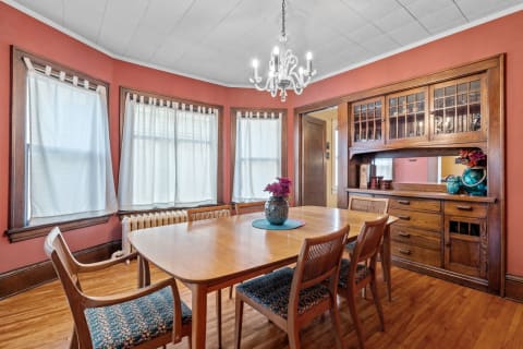 Cozy dining room with a wooden table, chairs, and decorative elements.