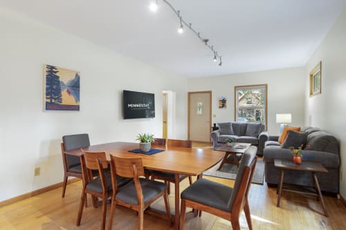 Gather around the beautiful wood dining table for meals and games, then relax on the comfy gray sectional while enjoying your favorite shows.