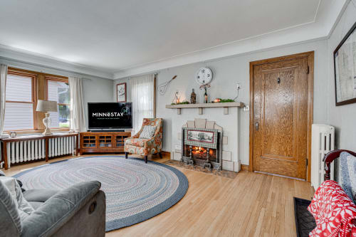 Cozy up in your charming living room with its warm fireplace, comfortable seating, and inviting atmosphere.