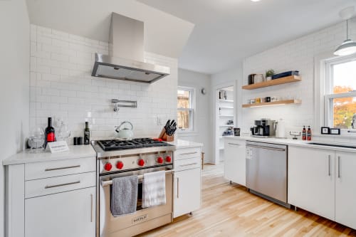 Your gourmet kitchen awaits with professional-grade appliances and pristine white subway tile backsplash for memorable meal preparation.