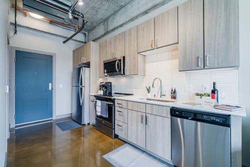 Your sleek modern kitchen features stainless steel appliances, ample counter space, and stylish wood-grain cabinets for effortless meal preparation.