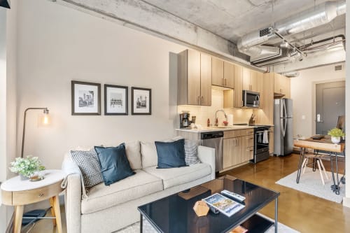 Settle into this stylish loft where modern comfort meets urban charm. Relax on the plush sofa or prepare meals in your sleek kitchen.