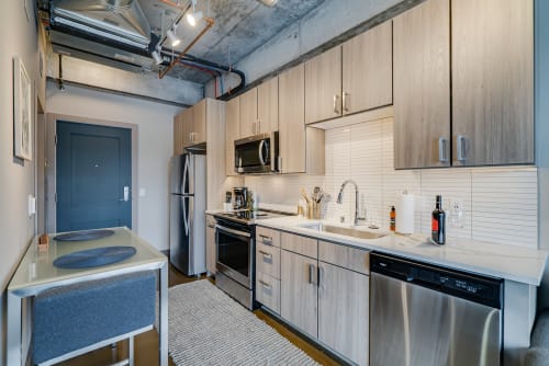 Your sleek modern kitchen features stainless steel appliances and warm wood cabinets, perfect for preparing meals during your stay.