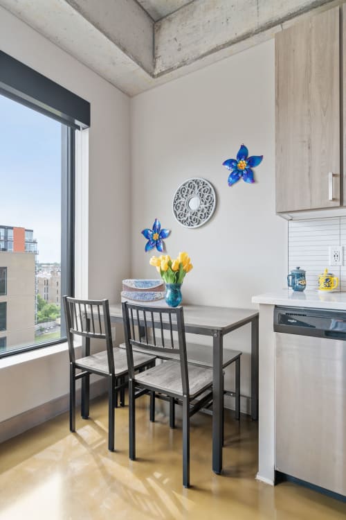 Start your mornings at this bright dining nook with city views and fresh tulips welcoming you to each new day.