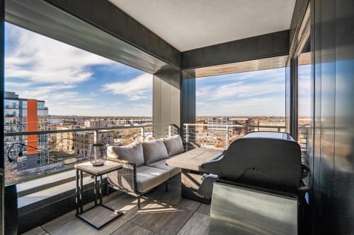 Your private balcony features plush seating and a gas grill, perfect for morning coffee or grilling dinner while enjoying sweeping city views.