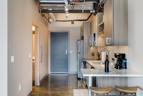 Your modern kitchen features sleek countertops, stainless steel appliances, and bar seating where you can enjoy morning coffee in contemporary comfort.