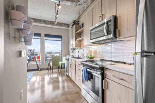 Your sleek kitchen features modern appliances and stunning city views, perfect for preparing meals while enjoying the urban scenery.