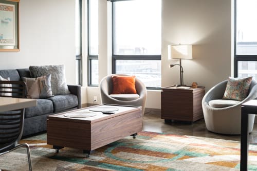 Unwind in your thoughtfully designed living space with plush seating, warm wood accents, and city views streaming through floor-to-ceiling windows.