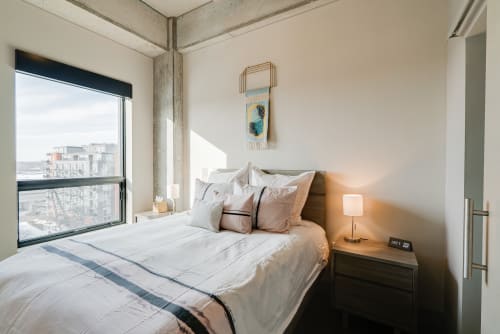 Drift off in this modern bedroom where city views and soft linens create your perfect urban retreat.