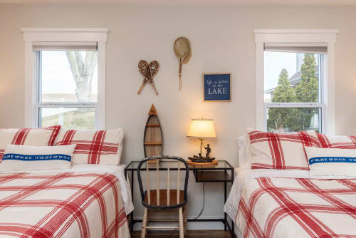 Cozy twin beds with charming lake-themed decor create your perfect retreat, complete with vintage nautical touches and peaceful views.